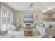 Light living room with view of outdoor pool area, white furniture, large windows, and coastal decor at 4711 Travertine Dr, Tampa, FL 33615