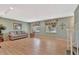 Bright living room featuring hardwood floors, neutral colors, and two sunny windows at 4711 Travertine Dr, Tampa, FL 33615