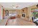 Inviting living room features a stone fireplace, hardwood floors, and a ceiling fan at 4711 Travertine Dr, Tampa, FL 33615