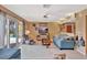 Living room featuring a ceiling fan, sliding glass door and adjacent wet bar at 4711 Travertine Dr, Tampa, FL 33615