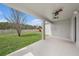 A covered patio offers views of the large backyard with a playground at 5027 Autumn Ridge Dr, Wesley Chapel, FL 33545