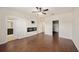 Bedroom with hardwood floors, a fireplace, a ceiling fan and an open closet at 5027 Autumn Ridge Dr, Wesley Chapel, FL 33545