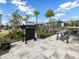 A stainless steel community grill and picnic table sit on a brick paver base in this well maintained community at 5027 Autumn Ridge Dr, Wesley Chapel, FL 33545