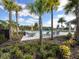 Enjoy the community pool and lounge area surrounded by lush landscaping and shaded by palm trees and umbrellas at 5027 Autumn Ridge Dr, Wesley Chapel, FL 33545