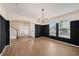 Dining room with decorative wainscoting, hardwood floors, an entry and a contemporary chandelier at 5027 Autumn Ridge Dr, Wesley Chapel, FL 33545