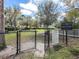 Fenced dog park with grass, benches, and shade trees for pets and their owners to enjoy at 5027 Autumn Ridge Dr, Wesley Chapel, FL 33545