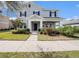 Charming two-story home with manicured lawn, lush landscaping, and welcoming covered entryway at 5027 Autumn Ridge Dr, Wesley Chapel, FL 33545