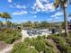 Community grilling area with picnic tables and lush landscaping under a bright blue sky at 5027 Autumn Ridge Dr, Wesley Chapel, FL 33545