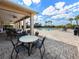Covered patio with tables overlooking the community pool area, with sunny skies in the background at 5027 Autumn Ridge Dr, Wesley Chapel, FL 33545
