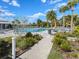 Community pool with lounge chairs and umbrellas under a blue, partly cloudy sky at 5027 Autumn Ridge Dr, Wesley Chapel, FL 33545