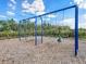 Community swings with a wooded backdrop and blue sky at 5027 Autumn Ridge Dr, Wesley Chapel, FL 33545