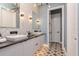 Stylish bathroom with double sinks, modern fixtures, white cabinets, and designer tile flooring at 6030 Printery St # 107, Tampa, FL 33616