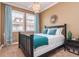 Bright bedroom with plantation shutters, a decorative ceiling fan and teal accents at 6030 Printery St # 107, Tampa, FL 33616