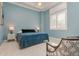Comfortable bedroom featuring stylish shutters, a tray ceiling with fan, and calming blue walls at 6030 Printery St # 107, Tampa, FL 33616