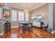Dining area featuring hardwood floors, a modern chandelier, and a stylish dining set with neutral-toned walls at 6030 Printery St # 107, Tampa, FL 33616