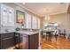 Kitchen area showcasing modern appliances and leads to the dining area with a stylish chandelier and furnishings at 6030 Printery St # 107, Tampa, FL 33616