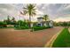 Community entrance with landscaped grounds, palm trees, and American flag at 6030 Printery St # 107, Tampa, FL 33616
