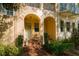 Inviting entryway with red brick steps leading to an arched doorway and a light blue door at 6030 Printery St # 107, Tampa, FL 33616