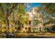 Charming townhome showcasing a light yellow color scheme, multiple balconies and lush, mature landscaping at 6030 Printery St # 107, Tampa, FL 33616