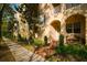 Charming townhouse exterior with manicured landscaping, arched entryway and a cozy bench at 6030 Printery St # 107, Tampa, FL 33616