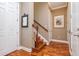 Hallway featuring wood floors, a wooden staircase and white trim at 6030 Printery St # 107, Tampa, FL 33616