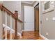 Hallway featuring wood floors, a wooden staircase and an elevator at 6030 Printery St # 107, Tampa, FL 33616