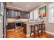 Modern kitchen featuring stainless steel appliances, dark wood cabinetry, and a breakfast bar with seating at 6030 Printery St # 107, Tampa, FL 33616