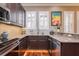 Modern kitchen with stainless steel appliances, dark wood cabinets, granite counters and hardwood floors at 6030 Printery St # 107, Tampa, FL 33616