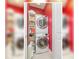 Functional laundry room featuring stacked washer and dryer and shelving units at 6030 Printery St # 107, Tampa, FL 33616