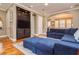 Cozy living room featuring hardwood floors, a large blue sectional sofa, a built-in media center and arched doorway at 6030 Printery St # 107, Tampa, FL 33616