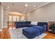 An inviting living room with a large blue sectional sofa, hardwood floors, and an open layout at 6030 Printery St # 107, Tampa, FL 33616