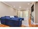 Inviting living room with hardwood floors, blue sectional sofa, built-in media center, and bright windows at 6030 Printery St # 107, Tampa, FL 33616