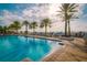 Lush waterfront pool with palm trees and lounge chairs overlooking the marina with an abundance of boat slips at 6030 Printery St # 107, Tampa, FL 33616