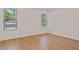 Bright bedroom with two windows, neutral walls and wood flooring at 7438 Burlington Ave, St Petersburg, FL 33710