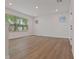 Large, light-filled room featuring wood floors, multiple windows and recessed lighting at 7438 Burlington Ave, St Petersburg, FL 33710