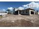 A new home under construction with a covered porch and garage, set on a spacious lot at 7438 Burlington Ave, St Petersburg, FL 33710