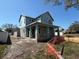 View of a two-story house under construction featuring stone accents, a covered porch, and a sunny sky at 7438 Burlington Ave, St Petersburg, FL 33710