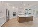 Modern kitchen featuring stainless steel appliances, a large island, and stylish pendant lighting at 7438 Burlington Ave, St Petersburg, FL 33710