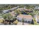 Aerial view of a neighborhood with homes surrounding a pond, showcasing the community's layout at 7631 Sailwinds Pass, Port Richey, FL 34668