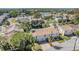 Overhead shot of the community, featuring houses, a pool, and a pond in a lush landscape at 7631 Sailwinds Pass, Port Richey, FL 34668
