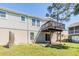 View of the home's backyard with a patio and deck, offering ample outdoor space at 7631 Sailwinds Pass, Port Richey, FL 34668