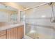 Bathroom featuring a tiled shower with a sliding glass door and a single sink vanity at 7631 Sailwinds Pass, Port Richey, FL 34668