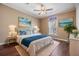 Spacious bedroom showcases a cozy bed, bedside tables, and beach-themed wall art at 7631 Sailwinds Pass, Port Richey, FL 34668