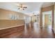 Open bedroom features hardwood flooring and view of private balcony at 7631 Sailwinds Pass, Port Richey, FL 34668