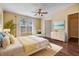 Bright bedroom featuring large windows, hardwood floors, and stylish furniture at 7631 Sailwinds Pass, Port Richey, FL 34668