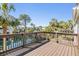 The wooden deck offers beautiful views of the water and surrounding palm trees at 7631 Sailwinds Pass, Port Richey, FL 34668