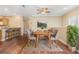 Cozy dining area with seating for six, modern decor, and hardwood floors at 7631 Sailwinds Pass, Port Richey, FL 34668