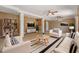 Bright living room features modern furniture, ceiling fans, and decorative shelving at 7631 Sailwinds Pass, Port Richey, FL 34668