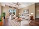 Comfortable living room with contemporary furniture, ceiling fan, and sliding glass doors at 7631 Sailwinds Pass, Port Richey, FL 34668