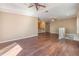 Open living area with wood floors, neutral walls, a ceiling fan, and staircase, perfect for entertaining at 7631 Sailwinds Pass, Port Richey, FL 34668
